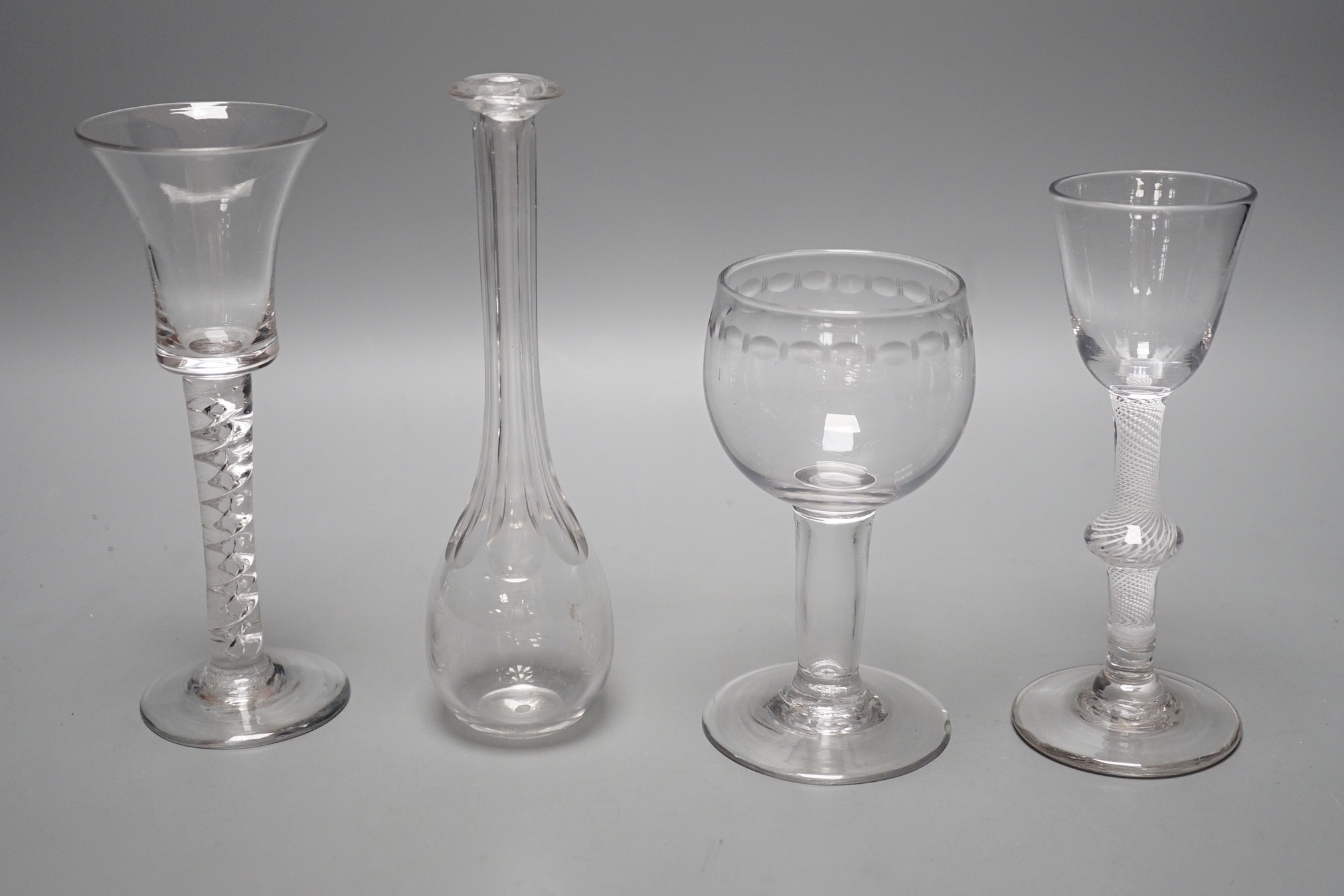 A George II mercury twist stem glass, a George III hollow stem glass, a toddy lifter and an air twist glass, tallest 17cm (4)